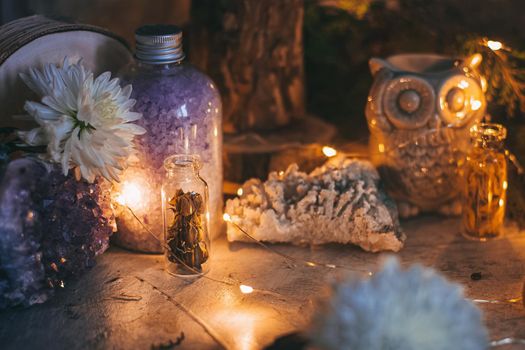 Mysterious halloween scene, witchcraft practicing, ritual candles. Fairytale, fairies theme, gemstones, flowers, love magic, white magic
