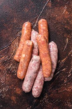Raw barbecue sausages Chorizo and Bratwurst with spices. Dark background. Top View
