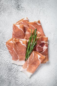 Italian prosciutto crudo parma ham on a table. White background. Top View