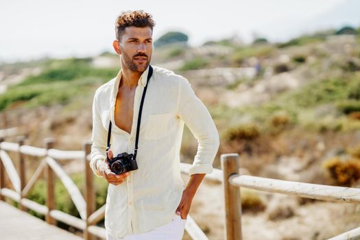 Handsome man photographing in a coastal area.