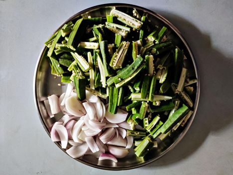 Freshly cut vegetables arranged in a plate for dinning preparations in home.