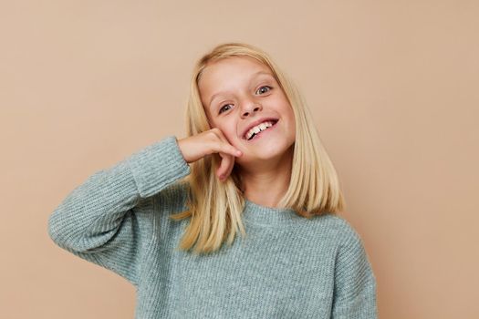 emotional girl in a sweater, grimaces posing studio