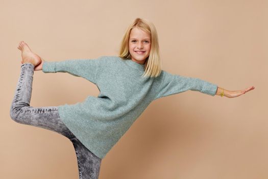 Little cute girl in a sweater, grimaces kids lifestyle concept