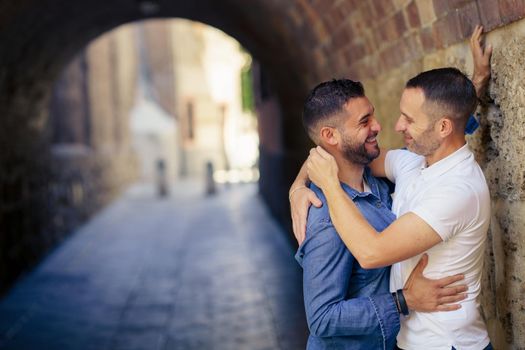 Gay couple hugging in a romantic moment outdoors