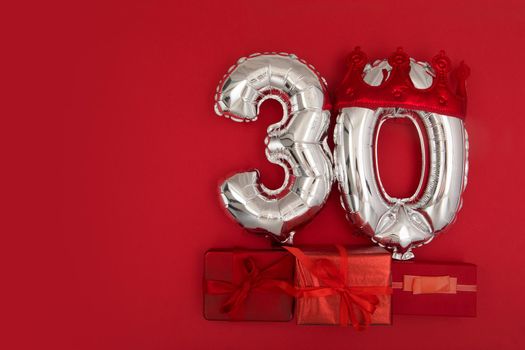 Foil balloons with number 30 on red background