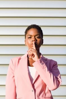 African American business woman doing silence gesture.