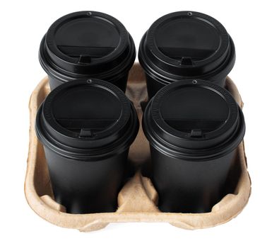 Four takeaway coffee cups in a tray isolated on white