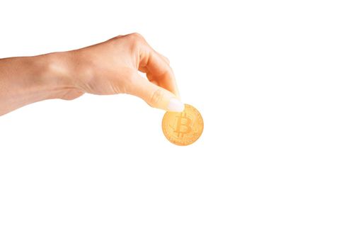 Woman’s hand holding glowing gold bitcoin.