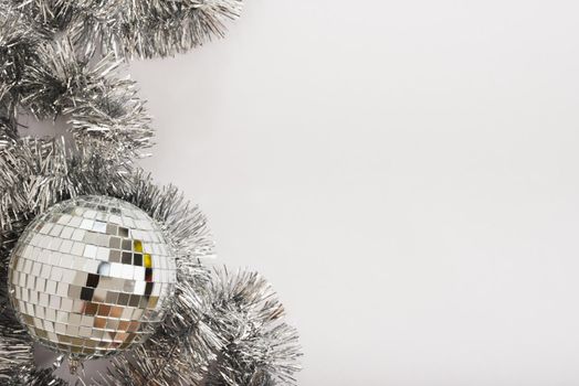 disco ball with tinsel on white table