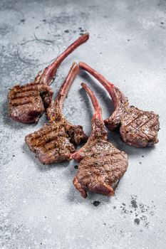 Grilled lamb mutton meat chops steaks. Gray background. Top view