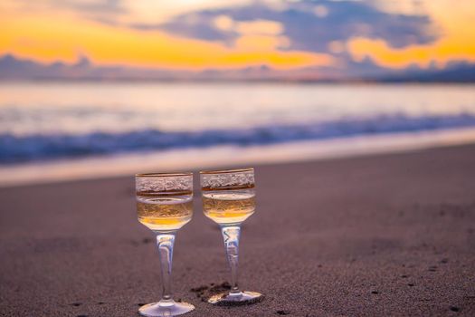 two glasses on the white sandy beach