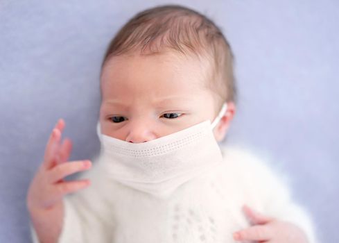 Newborn wearing medical mask