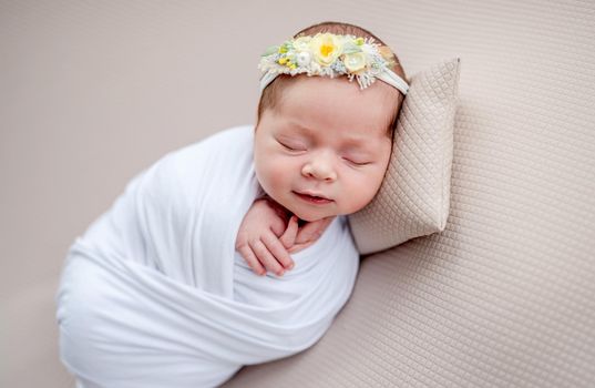 Smiling newborn in floral rim