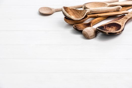 Wooden spoons on white wooden background