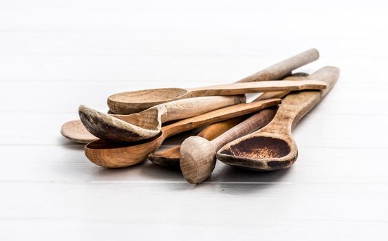 Bunch of wooden spoons on white background