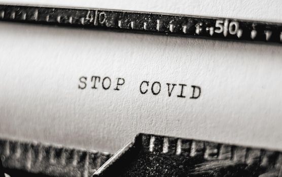 Text Stop Covid on retro typewriter