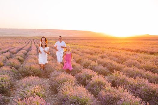 Family of four in lavender flowers field