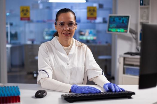 Portrait of biochemist researcher typing biochemistry expertise