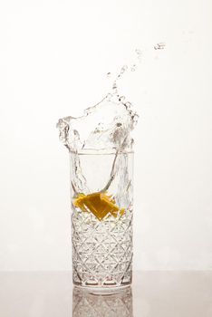 Fresh glass of water with lemon, water splash
