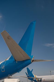 Aircraft tail of international airlines in airport with blue sky in the background