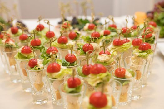 Triangular rows of cocktails with vegetables on the banquet table