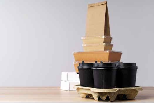 Many various take-out food containers, pizza box, coffee cups and paper bags on light grey background