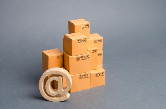 stack of cardboard boxes and email symbol commercial AT. E-commerce. Internet sales. development of network trading, automation and development of logistics supplies, reducing personnel costs, storage