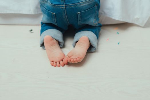 Children's bare feet. Child's bare feet on the wooden floor