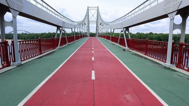 Park pedestrian bridge over the Dnieper River, which connects the central part of Kiev with the park area and the beaches of Trukhanovy Island. Without people.