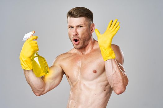 male naked torso wearing rubber gloves cleaning supplies housework isolated background