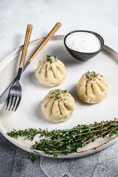 Asian Steamed Dumplings Manti with mince meat on a plate. White background. Top view