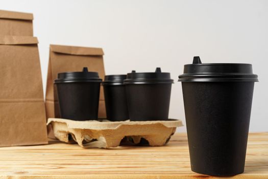 Paper bags with take away food and coffee cups containers