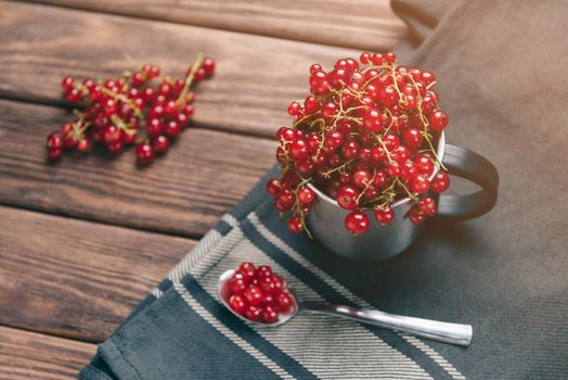 Fresh red ripe currant berries in a cup.