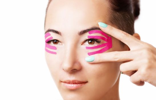 Woman with kinesiology tape on eyelid