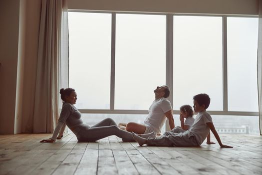 Sporty family relaxing after domestic workout together