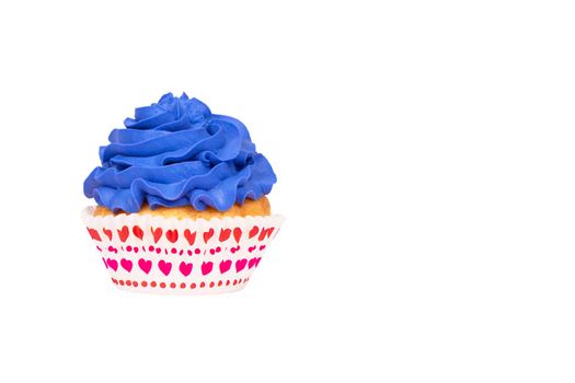 Cupcake with blue buttercream frosting isolated on white background. Copy space.