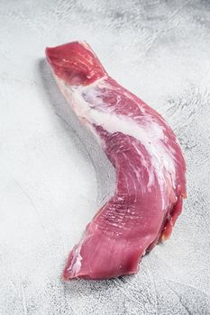 Raw pork tenderloin meat. White background. Top view
