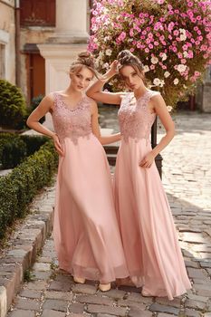 European girls bridesmaids in pink dresses having fun