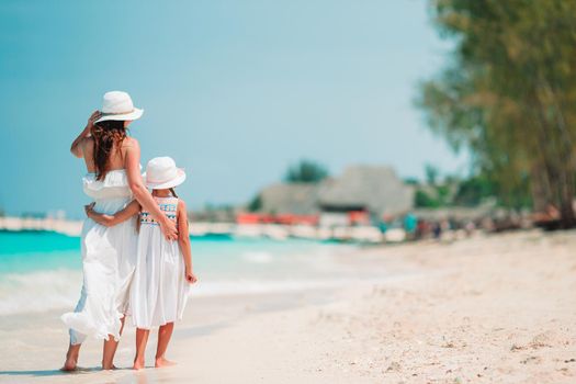 Beautiful mother and daughter on Caribbean beach