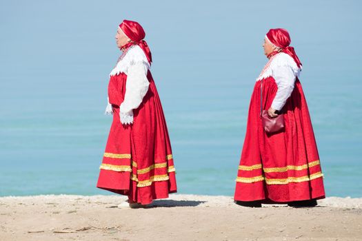 20 August 2018, Krasnovidovo, Russia - mature women in russian folk costume walking