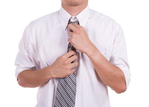 Business man tying the necktie