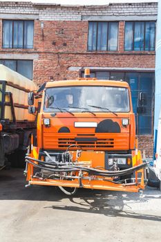 Kamaz truck stands in the parking on brick building background