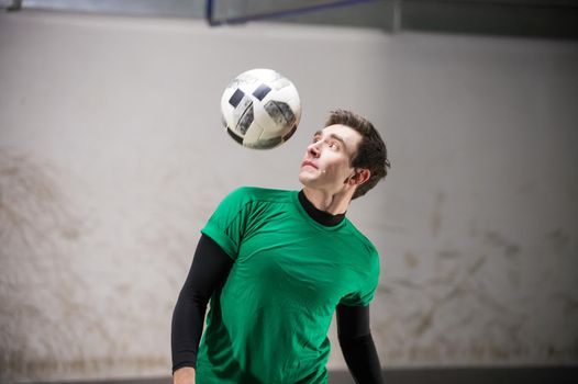 Soccer player training his skills with a ball