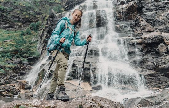 Backpacker woman and waterfall