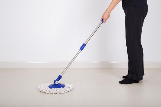 woman legs with mop cleaning floor