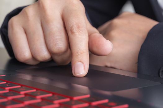 business hand working on a laptop touchpad