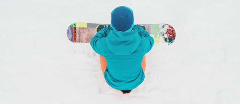 Snowboarder resting on snow