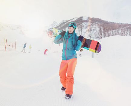 Girl with snowboard on ski resort