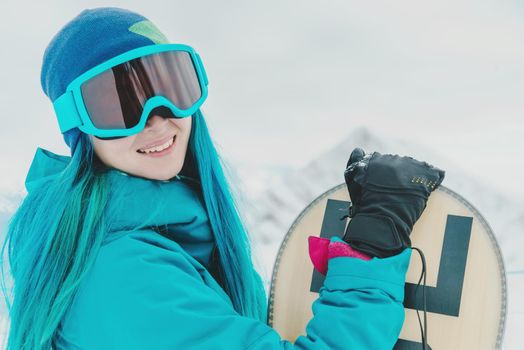 Woman snowboarder in protective sunglasses