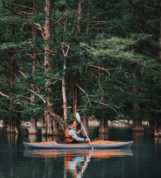Man kayaking on lake in summer